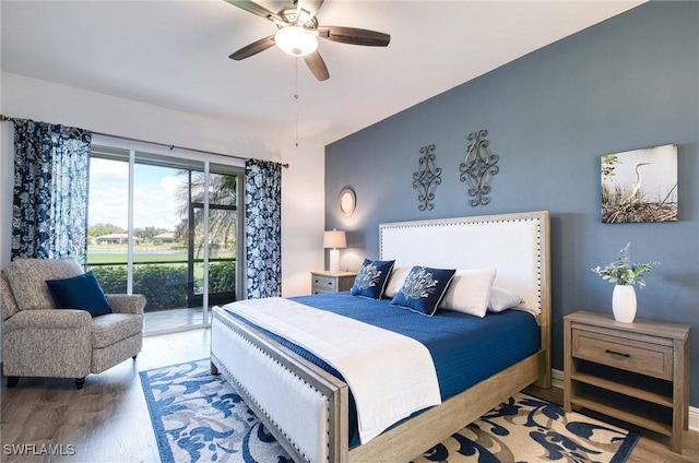 bedroom featuring access to exterior, wood-type flooring, and ceiling fan