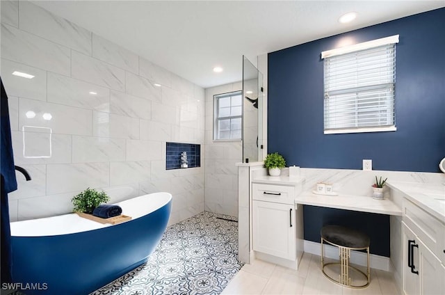 bathroom with shower with separate bathtub, vanity, and tile walls