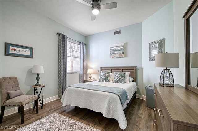 bedroom featuring ceiling fan and dark wood-type flooring