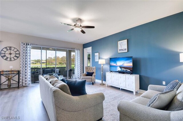 living room with hardwood / wood-style flooring and ceiling fan