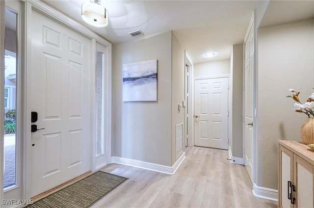 foyer entrance with light hardwood / wood-style flooring