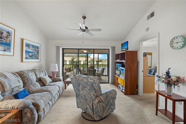 living room with light carpet, visible vents, high vaulted ceiling, and a ceiling fan