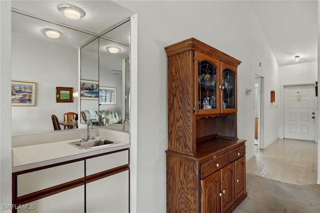 interior space with light tile patterned floors and sink