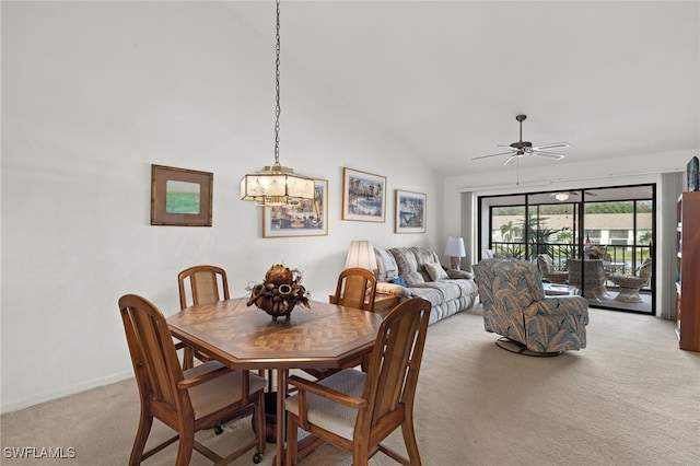 dining space with light colored carpet, vaulted ceiling, and ceiling fan