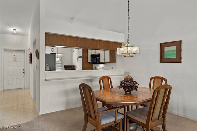 dining area featuring light colored carpet