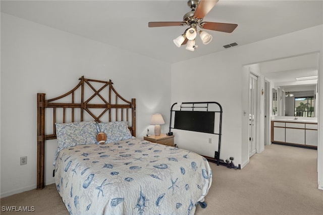 carpeted bedroom featuring connected bathroom and ceiling fan