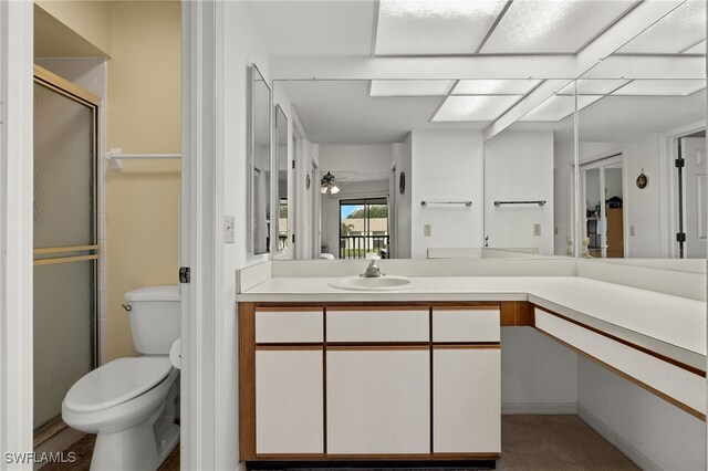 full bath featuring toilet, vanity, a ceiling fan, and a shower with shower door