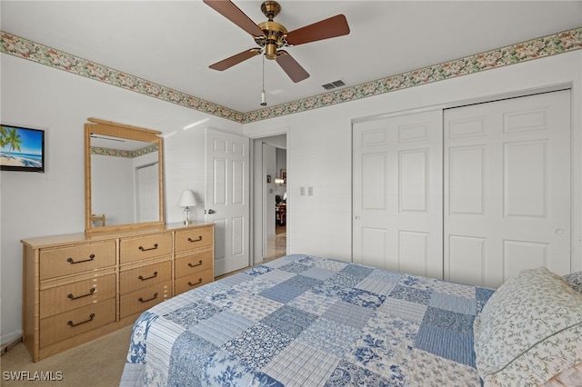 carpeted bedroom with ceiling fan and a closet