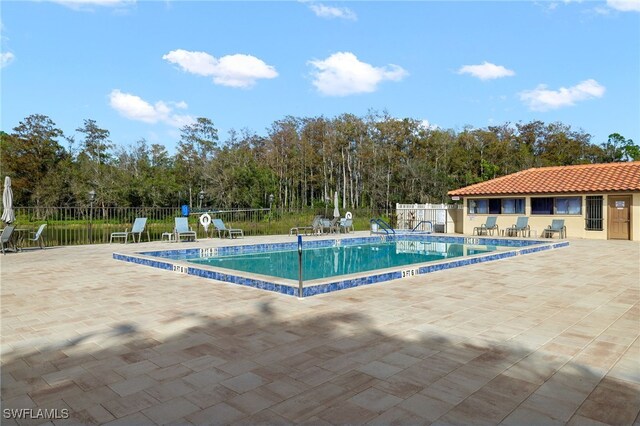 pool featuring a patio and fence