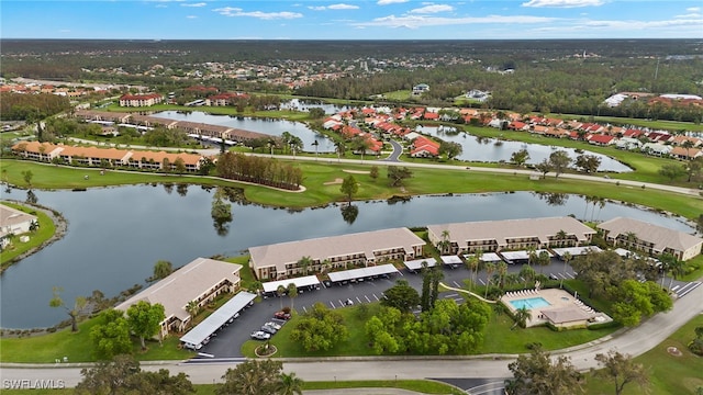 drone / aerial view featuring a residential view and a water view