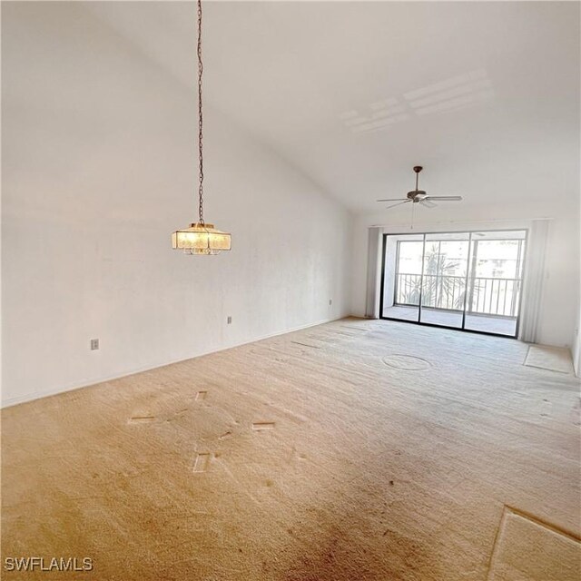 carpeted empty room featuring a ceiling fan and vaulted ceiling