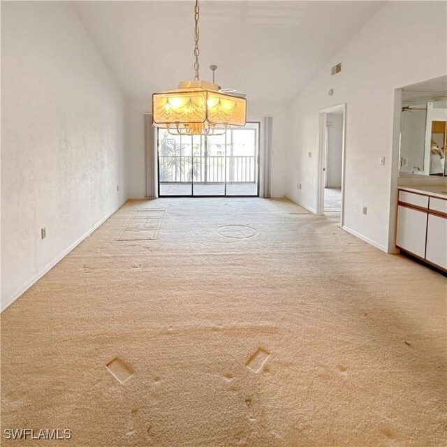 interior space with high vaulted ceiling and light carpet