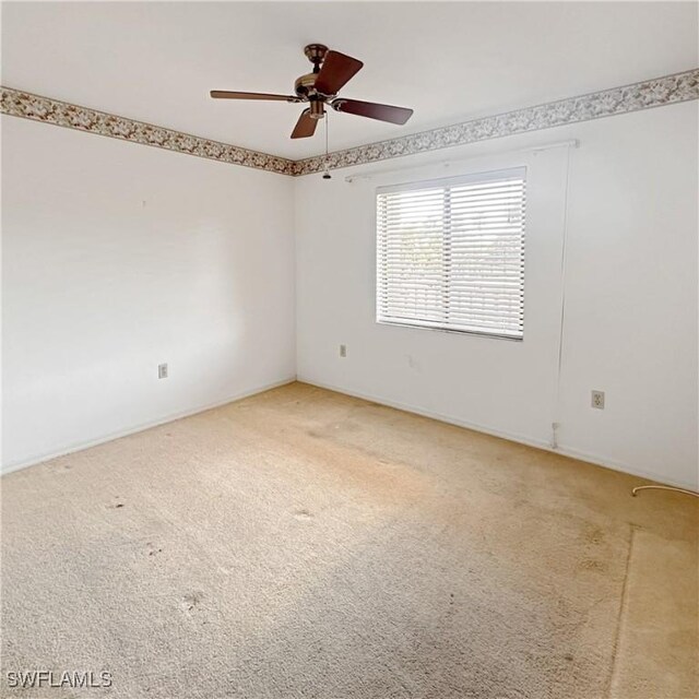 unfurnished room featuring light colored carpet and ceiling fan