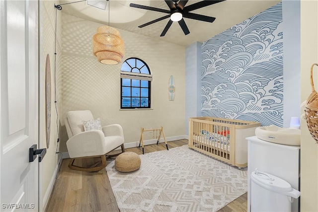 sitting room with ceiling fan and hardwood / wood-style floors