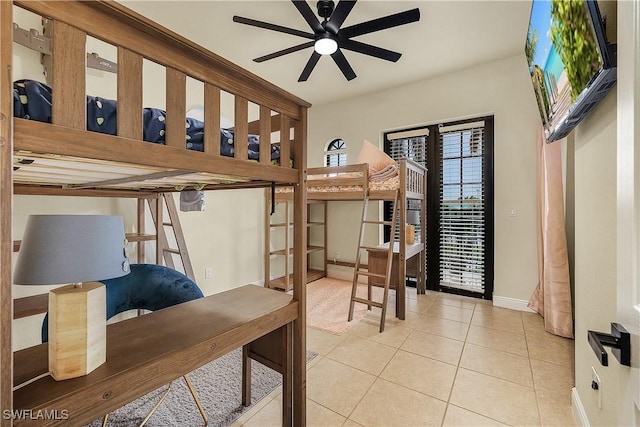 bedroom with ceiling fan, light tile patterned flooring, french doors, and multiple windows