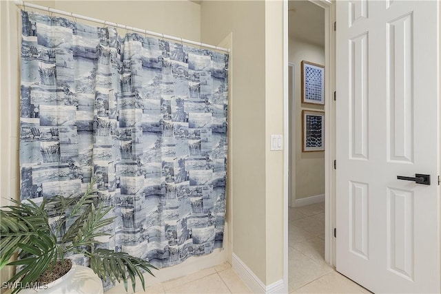 bathroom with tile patterned floors and walk in shower