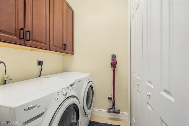 laundry room featuring independent washer and dryer and cabinets