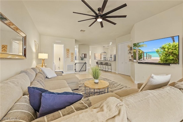 living room with ceiling fan and light tile patterned floors