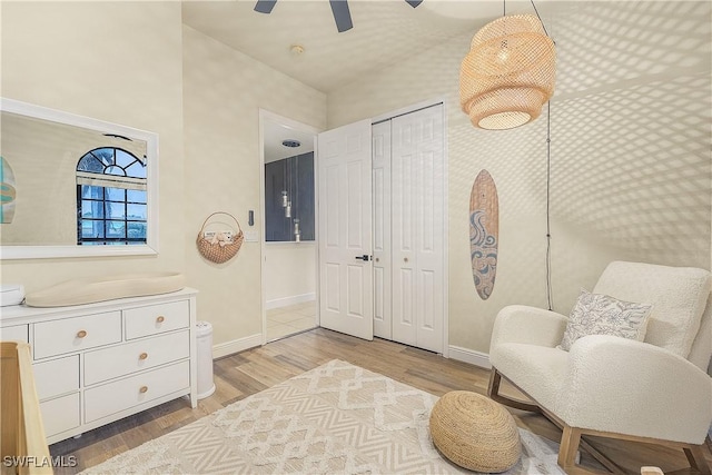 living area featuring ceiling fan and light hardwood / wood-style flooring