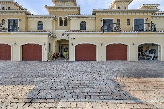 mediterranean / spanish-style house with a balcony and a garage