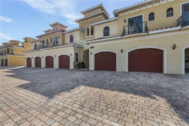 mediterranean / spanish-style house with a balcony and a garage