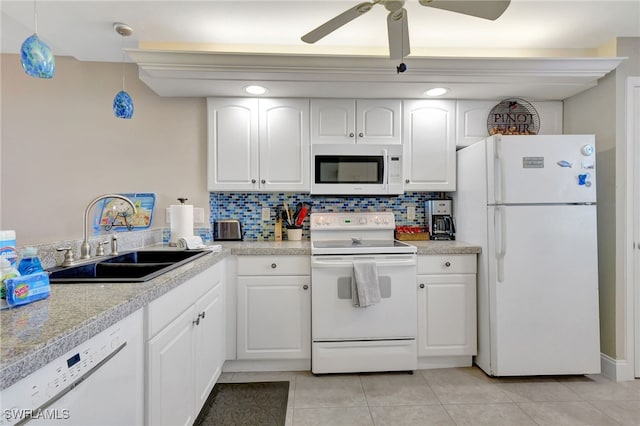 kitchen with sink, hanging light fixtures, backsplash, white appliances, and white cabinets