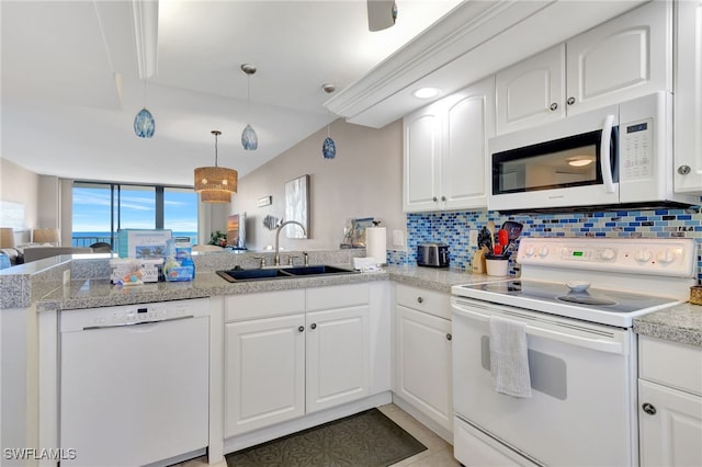 kitchen with kitchen peninsula, white cabinetry, sink, and white appliances