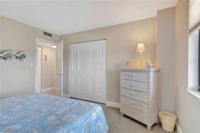 carpeted bedroom with a closet