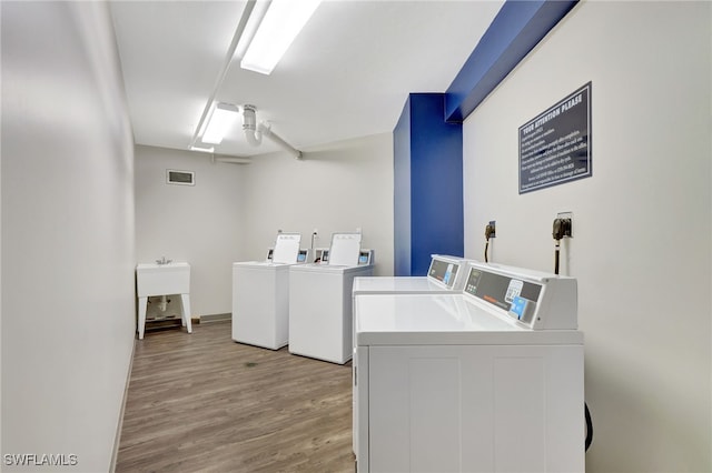 laundry room with separate washer and dryer, light hardwood / wood-style flooring, and ceiling fan