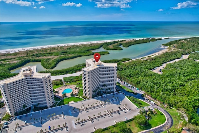 bird's eye view featuring a water view and a beach view