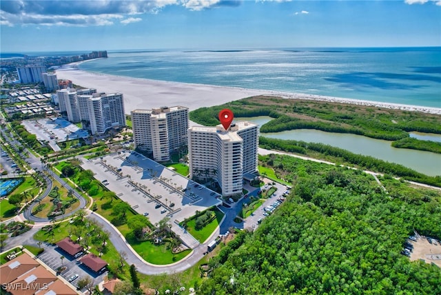 birds eye view of property featuring a water view and a beach view