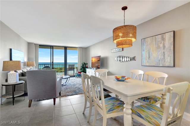 dining area featuring light tile patterned floors and floor to ceiling windows