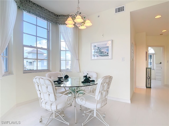 dining area with an inviting chandelier and light tile patterned flooring