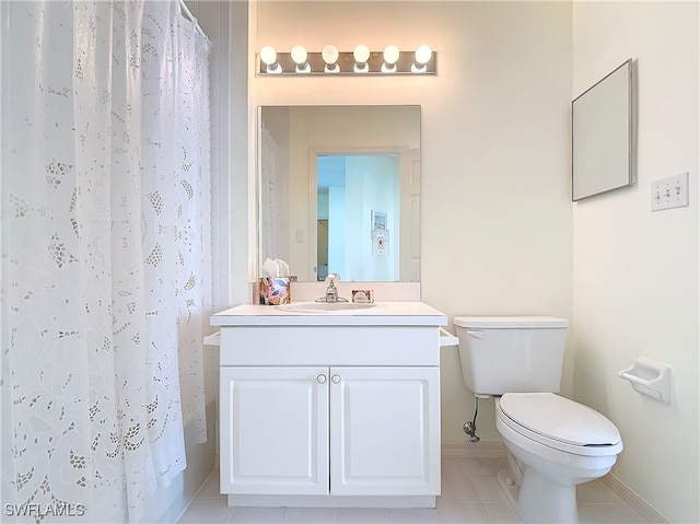 bathroom with tile patterned floors, toilet, vanity, and walk in shower