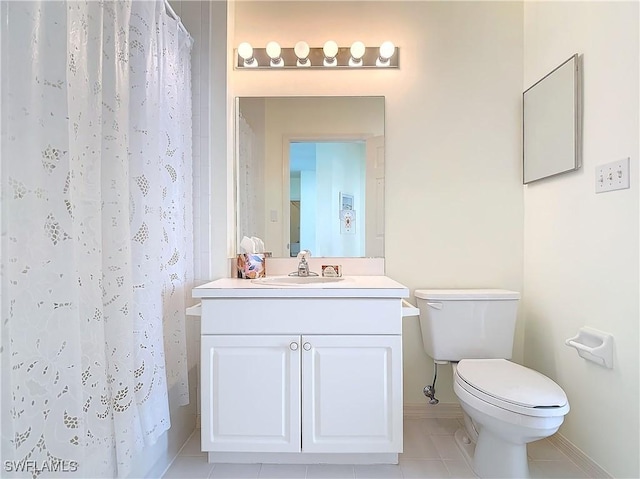 22700 Island Pines Way Unit 503, Fort Myers Beach, FL 33931 - full bath with baseboards, toilet, vanity, tile patterned floors, and a shower with shower curtain