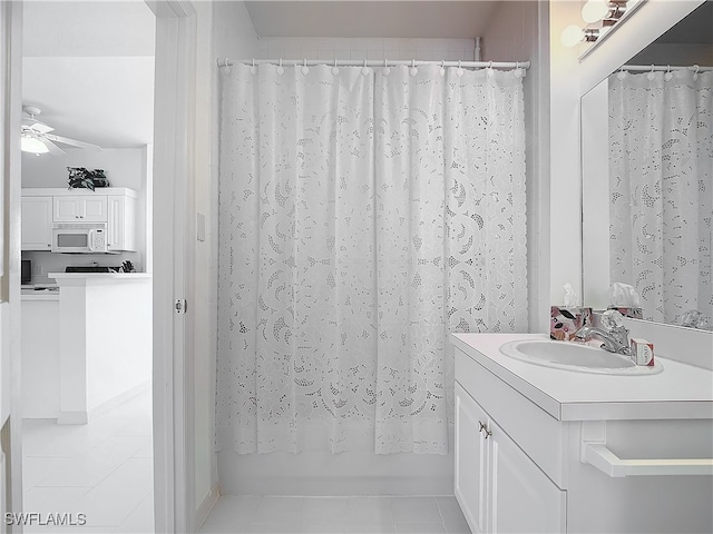 bathroom featuring tile patterned floors, ceiling fan, vanity, and shower / bath combo