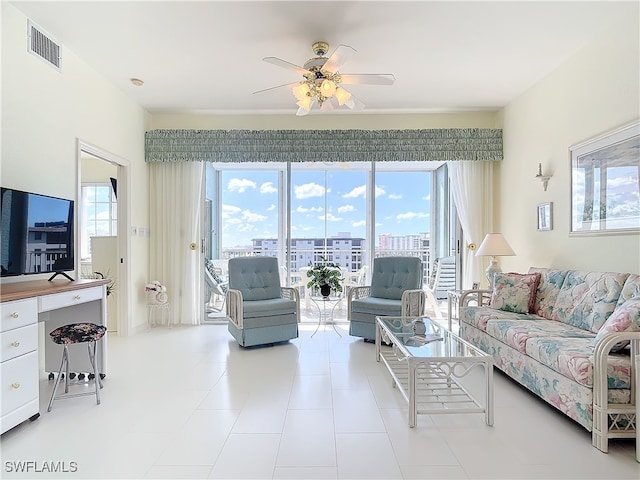 tiled living room featuring ceiling fan and a healthy amount of sunlight