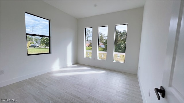 unfurnished room featuring plenty of natural light