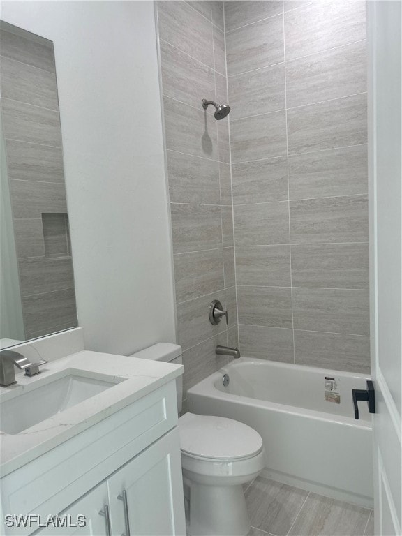 full bathroom with vanity, toilet, and tiled shower / bath combo