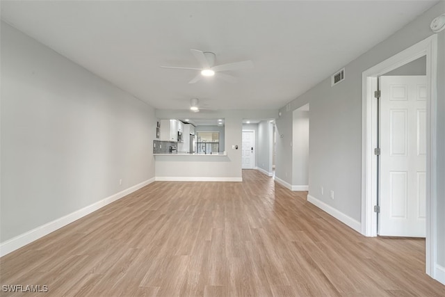 unfurnished living room with light wood-type flooring and ceiling fan