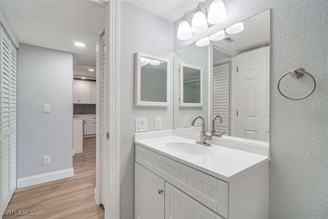 bathroom featuring hardwood / wood-style floors and vanity