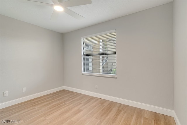 empty room with light hardwood / wood-style floors and ceiling fan