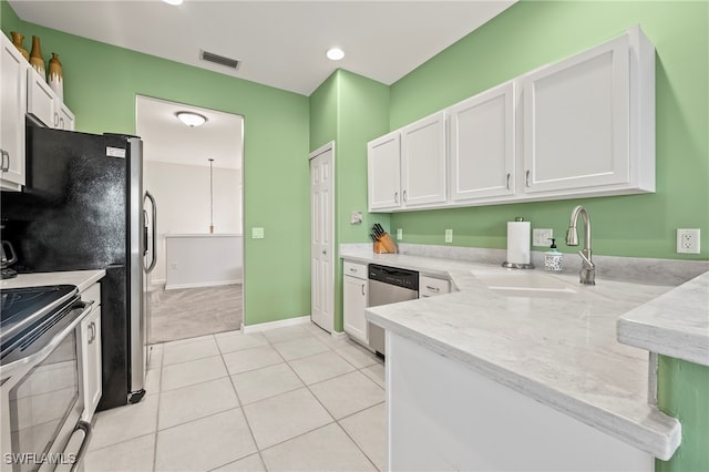 kitchen with appliances with stainless steel finishes, sink, and white cabinets