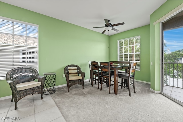 dining area featuring light colored carpet and ceiling fan