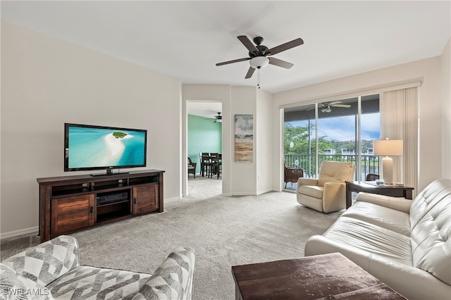 carpeted living room with ceiling fan