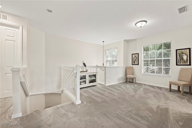 sitting room featuring light colored carpet