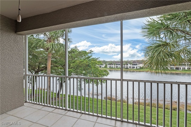 unfurnished sunroom with a healthy amount of sunlight and a water view