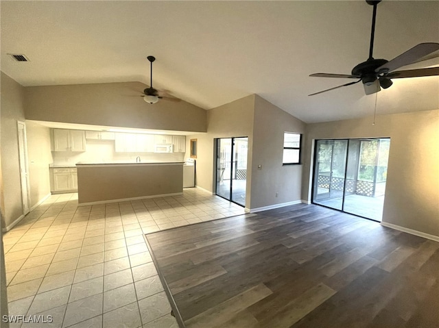 interior space with lofted ceiling, ceiling fan, and light hardwood / wood-style flooring