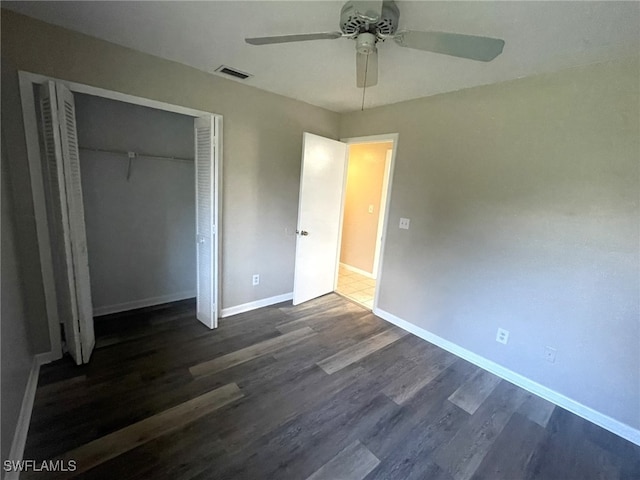 unfurnished bedroom featuring a closet, ceiling fan, and dark hardwood / wood-style floors