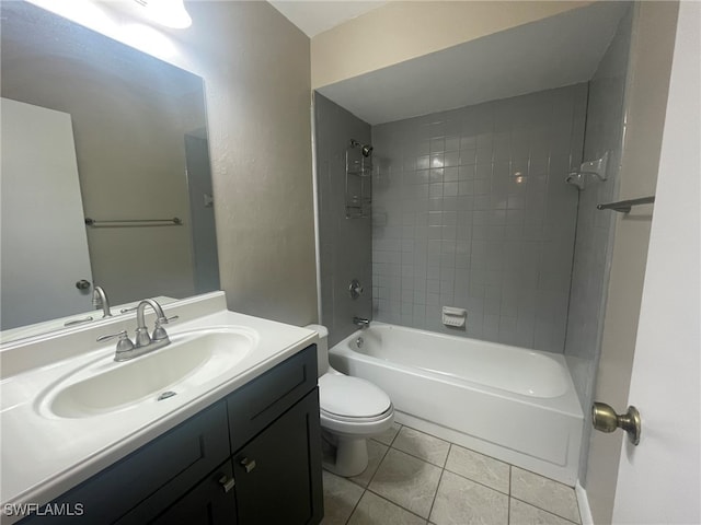 full bathroom featuring toilet, vanity, tiled shower / bath, and tile patterned flooring